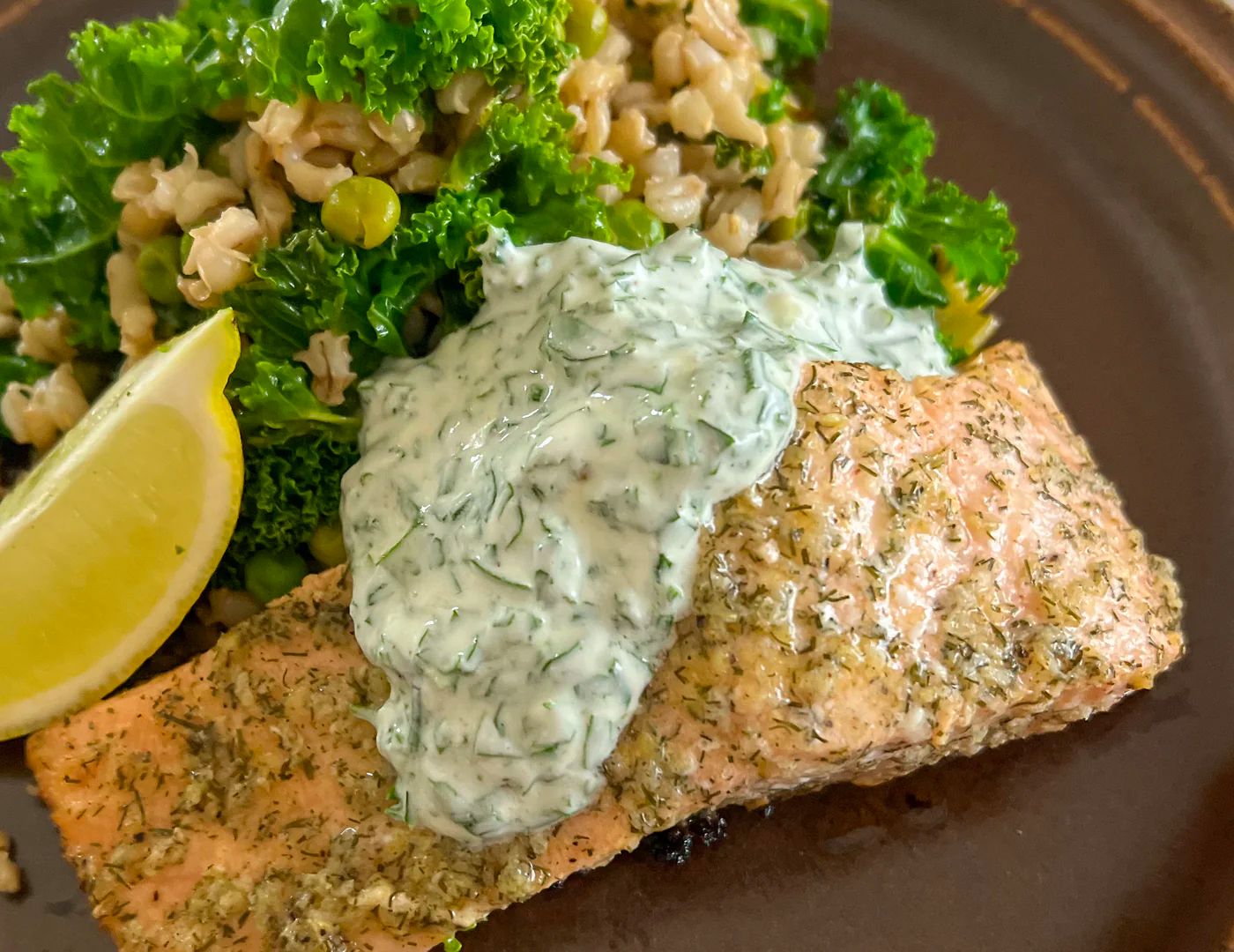 Baked salmon and greens with herby greek yoghurt sauce